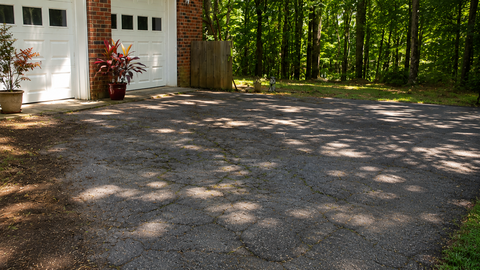 Cracked driveway before resurfacing by May's Paving